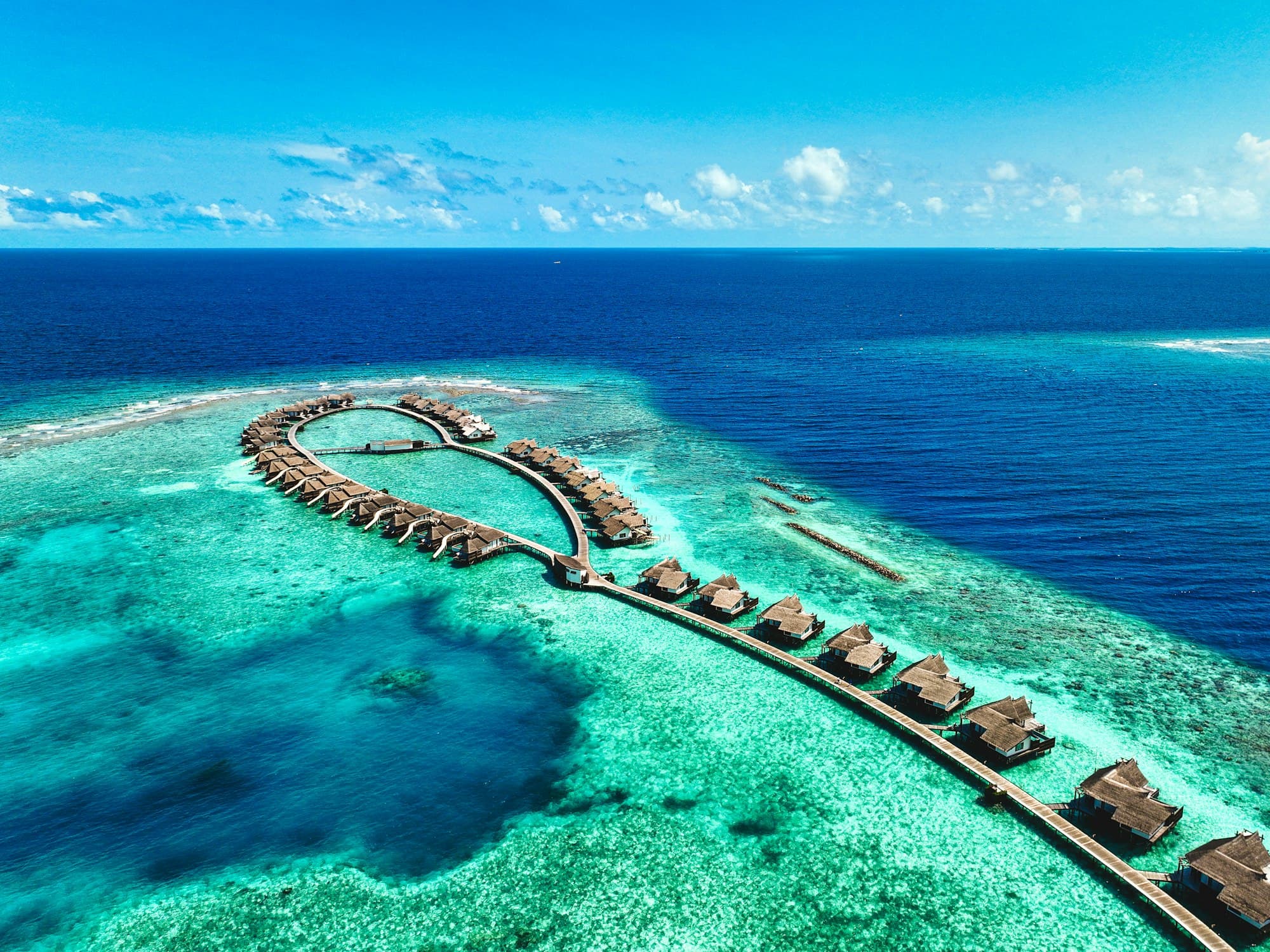 A resort with overwater villas seen from the air